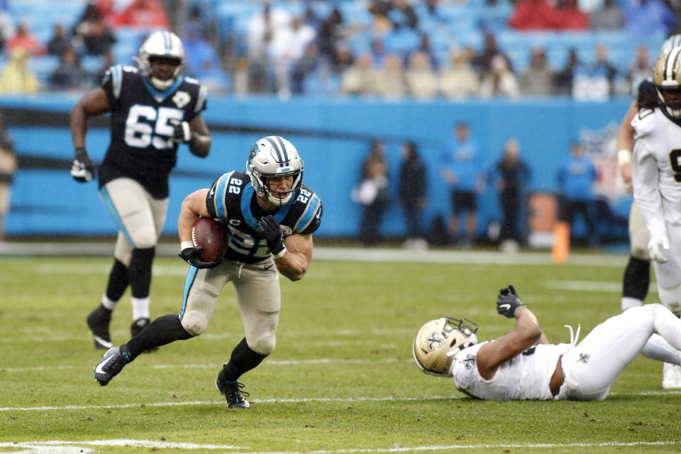 Carolina Panthers running back Christian McCaffrey (22) breaks a tackle by New Orleans Saints linebacker Craig Robertson (52) during the second half of an NFL football game in Charlotte, N.C., Sunday, Dec. 29, 2019. McCaffrey broke a record on the play to become the third player in NFL history to tally 1000 rushing and 1000 receiving yards in the same season. (AP Photo/Brian Blanco)