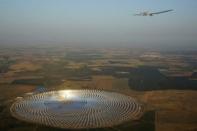 Solar Impulse 2, a solar-powered plane piloted by Swiss aviator Andre Boschberg, flies over the Gemasolar Thermosolar Plant in Seville, Spain after taking off towards Cairo, Egypt, from the San Pablo airport, July 11, 2016. Amalie Decloux, Jean Revillard/SI2/Handout via Reuters