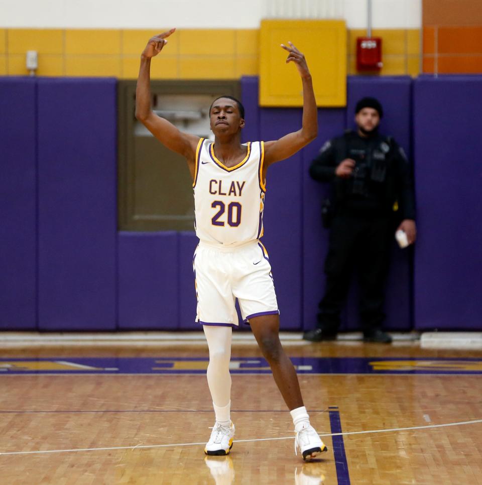 Clay sophomore Ryan Harris celebrates after making a '3' during a boys basketball game against New Prairie Friday, Feb. 16, 2024, at Clay High School in South Bend.