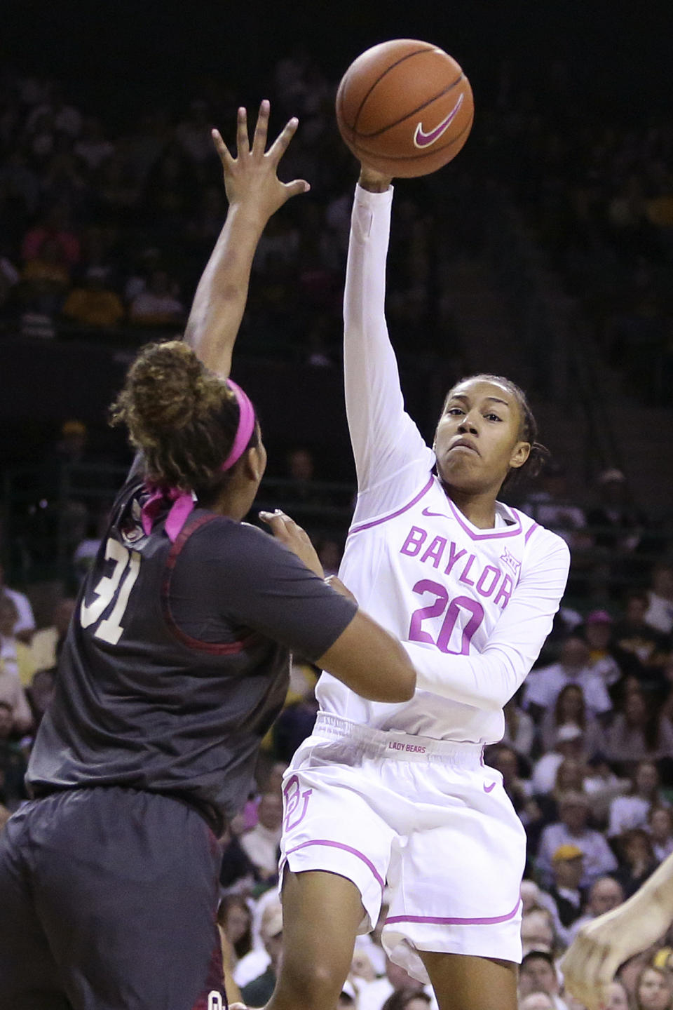 Baylor guard Juicy Landrum (20) attempts to shoot over Oklahoma center Aspen Williston (31) in the first half of an NCAA college basketball game Saturday, Feb. 22, 2020, in Waco, Texas. (AP Photo/Jerry Larson)