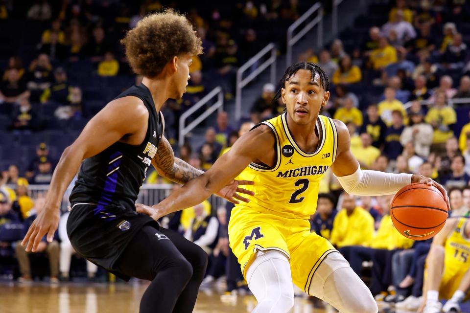 Michigan Wolverines guard Kobe Bufkin (2) dribbles defended by IPFW Mastodons guard Quinton Morton-Robertson (11) in the first half at Crisler Center.