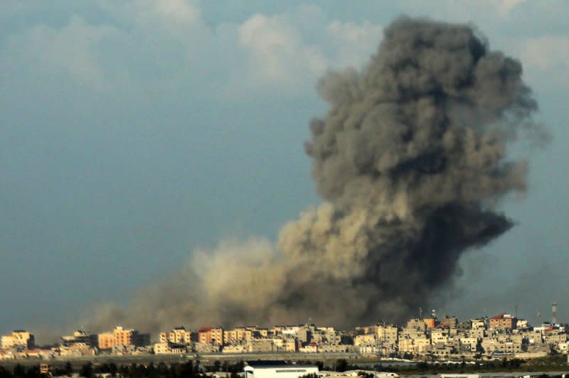 Smoke billows over Khan Younis in the southern Gaza Strip during an Israeli bombardment on Wednesday. U.S. National Security Council spokesman John Kirby on Wednesday said IDF forces are adjusting their combat operations in Gaza to what he called "low-intensity" operations. Photo by Ismael Mohamad/UPI