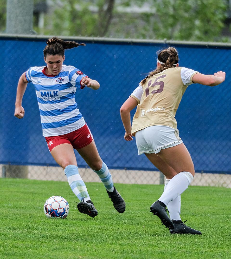 Lansing United forward Camryn Evans gets past Margaret Berry from Detroit City FC at the East Lansing Soccer Complex Sunday, May 23, 2021.