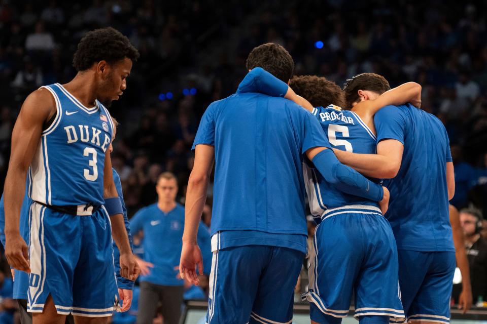 Duke's Tyrese Proctor (5) is helped off the court by teammates in the first half against Georgia Tech.