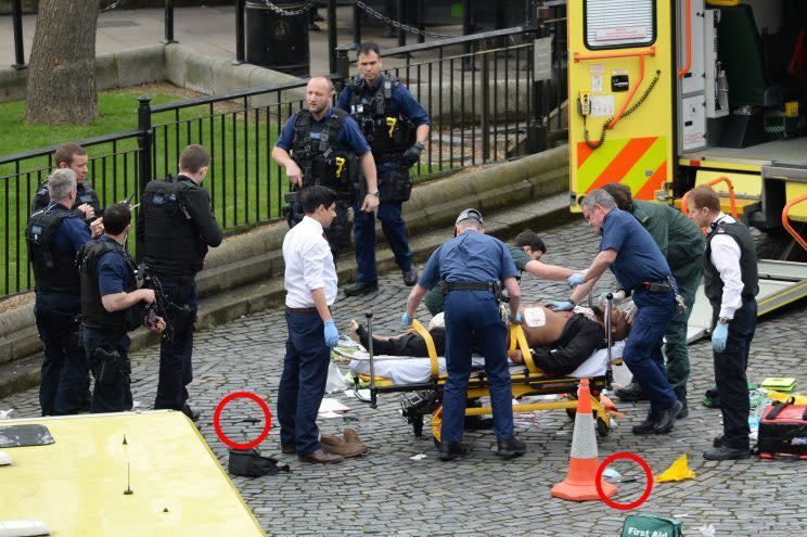 Four confirmed dead including a police officer and the attacker (on stretcher). The attacker had driven his car over Westminster Bridge and Parliament Square hitting many people before crashing into Parliment gate. He pulled out two knives (in red circles) and stabbed a police officer before being shot.