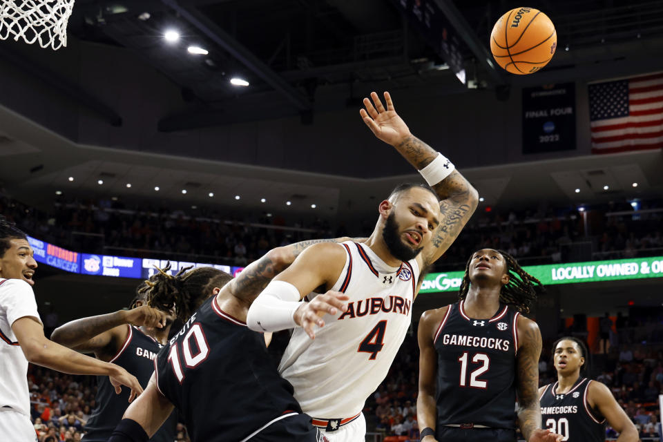 Auburn forward Johni Broome (4) is fouled by South Carolina guard Myles Stute (10) during the second half of an NCAA college basketball game Wednesday, Feb. 14, 2024, in Auburn, Ala. (AP Photo/Butch Dill)