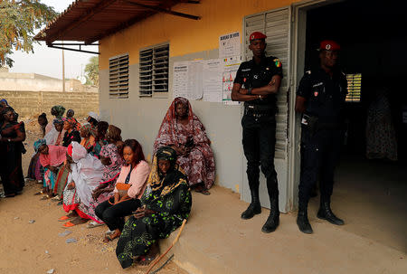 Members of security forces stand guard as people wait for their turn to cast their votes during presidential election, at a polling station in Fatick, Senegal February 24, 2019. REUTERS/Zohra Bensemra