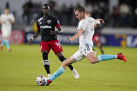 New England Revolution defender Henry Kessler (4) passes the ball in front of D.C. United forward Nigel Robertha (19) during the second half of an MLS soccer match, Wednesday, Oct. 20, 2021, in Washington. The Revolution won 3-2. (AP Photo/Alex Brandon)