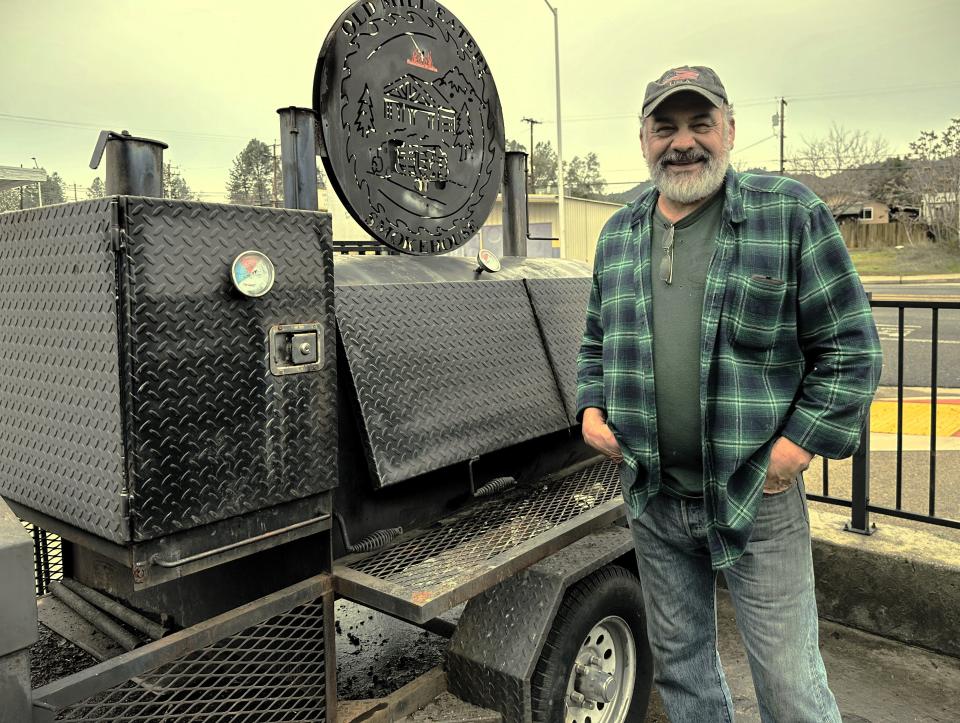 Fernando Perez, owner of the Old Mill Eatery & Smokehouse, stands beside his smoker along Shasta Dam Boulevard in Shasta Lake on January 20, 2024.