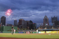 Fireworks explode as Pittsburgh Pirates Adam Frazier, center right, rounds second base after hitting a solo home run against the Washington Nationals in the third of a baseball game Thursday, Aug. 22, 2019, in Pittsburgh. (AP Photo/Keith Srakocic)