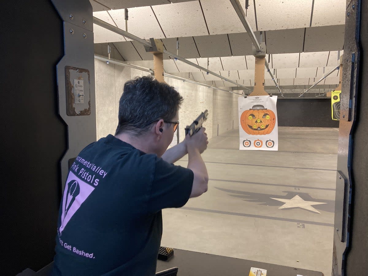 Deanna Sykes, head of the Sacramento chapter of the Pink Pistols gun group, at a shooting meet-up in May 2022 (Io Dodds)