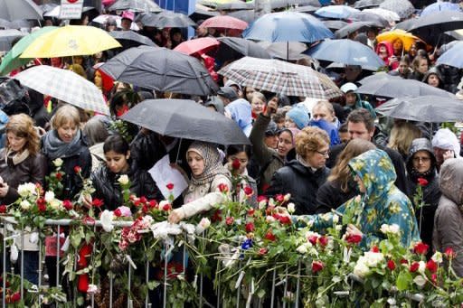 Tens of thousands of rose-waving Norwegians gather in rain-drenched Oslo to deride mass murderer Anders Behring Breivik by singing a song he hates, viewing it as Marxist indoctrination