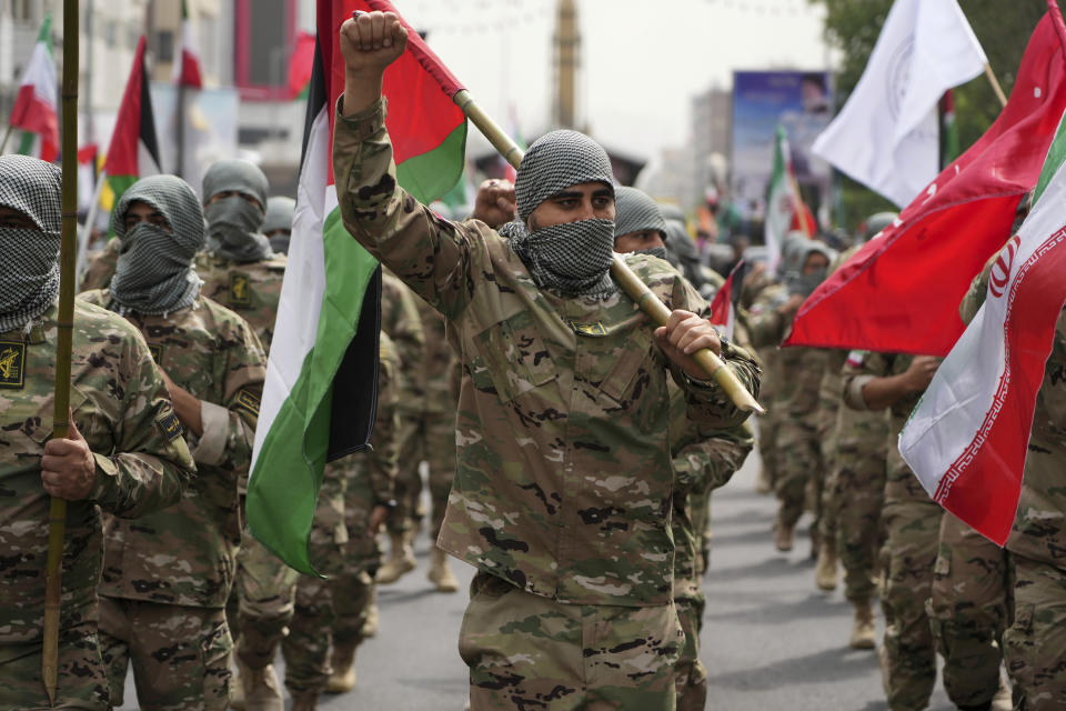 Basij paramilitary force members march during the annual pro-Palestinian Al-Quds, or Jerusalem, Day rally as they cover their faces in the style of Palestinian and Lebanese militants in Tehran, Iran, Friday, April 29, 2022. Iran does not recognize Israel and supports Hamas and Hezbollah, militant groups that oppose it. Signs on head bands show support Iranian supreme leader Ayatollah Ali Khamenei. (AP Photo/Vahid Salemi)