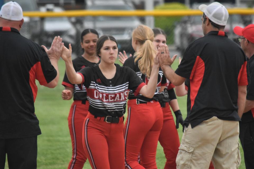 Cambree Cline high-fives a pair of Orleans coaches while being announced as part of the Bulldogs' starting lineup against Mitchell.