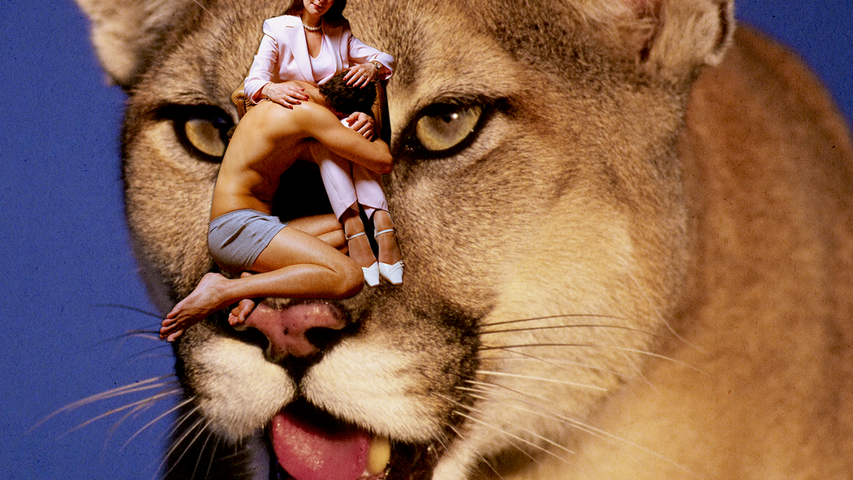 a man cuddling in a woman's lap with a cougar in the background