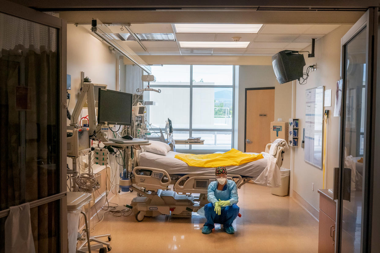 A nurse at Three Rivers Asante Medical Center waits for her next COVID-19 case to be brought from the emergency room shortly after a deceased patient was removed the from the same Intensive Care Unit room in Grants Pass, Ore., on Sept. 9, 2021.