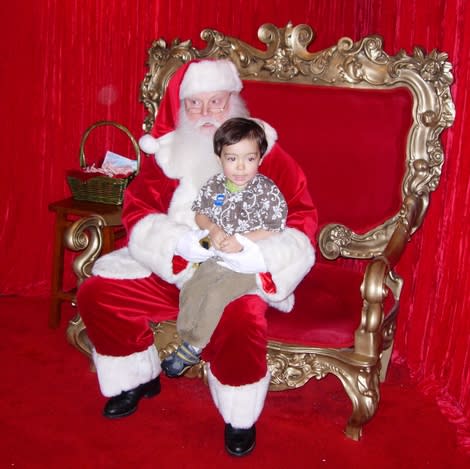 <div class="caption-credit"> Photo by: Angie Hughes</div><p> "We are not sure if Santa was just having a bad day, or had previously been in an argument with one of his elves, but this was the biggest smile we could coax out of him. He was not having it! Our 2.5-year-old son, Avery, was not affected by Santa's grumpiness and was happy to focus on the piece of candy he was given prior to his sitting. What was ironic about this whole experience was that, at $50, it was more than we had paid in the previous two years combined for Santa visits, it came with this elaborate and over-the-top 'Christmas in the Grove' DVD, and for what was supposed to be the finale, Santa was just plain irritable at best." - Angie Hughes, <a href="http://voices.yahoo.com/grumpiness-grove-11918731.html?cat=25" data-ylk="slk:Grumpiness in the Grove;elm:context_link;itc:0;sec:content-canvas;outcm:mb_qualified_link;_E:mb_qualified_link;ct:story;" class="link  yahoo-link">Grumpiness in the Grove</a> </p>