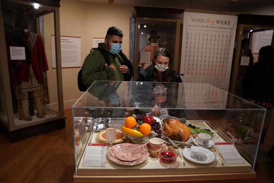 Visitors look over a Thanksgiving meal exhibit at the Pilgrim Hall Museum on Nov. 25, 2021 in Plymouth, Massachusetts. Native American historians have said that there is not much evidence that suggests they ate what is traditionally served at Thanksgiving today.