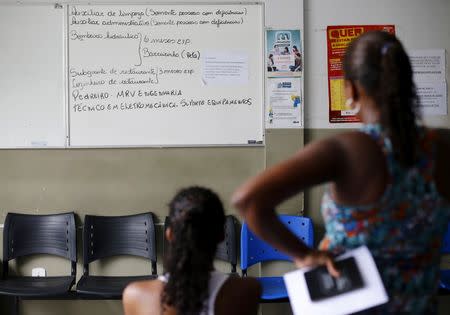 Unemployed women check a board with job opportunities at a job agency in Itaborai March 31, 2015. REUTERS/Ricardo Moraes/File Photo