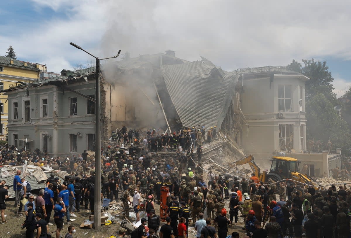 Rescue workers at the site of a rocket strike on the 'Okhmadyt' children's hospital in Kyiv (EPA)