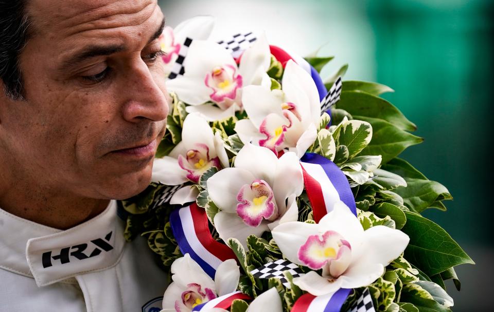 Meyer Shank Racing driver Helio Castroneves (6) lays the wreath over his shoulder to pose for photos after winning the 105th running of the Indianapolis 500, Monday, May 31, 2021, at Indianapolis Motor Speedway. This is the fourth Indianapolis 500 Castroneves has won. 