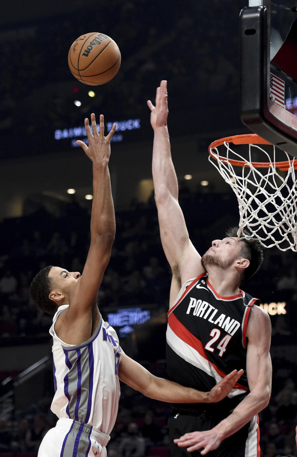 Sacramento Kings forward Keegan Murray, left, drives to the basket against Portland Trail Blazers forward Drew Eubanks, right, during the first half of an NBA basketball game in Portland, Ore., Friday, March 31, 2023. (AP Photo/Steve Dykes)