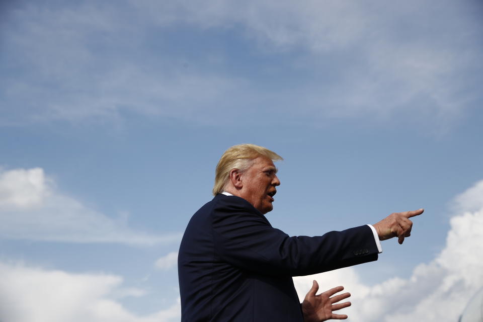 President Donald Trump speaks with reporters before boarding Air Force One at Morristown Municipal Airport in Morristown, N.J., Sunday, Aug. 18, 2019. (AP Photo/Patrick Semansky)