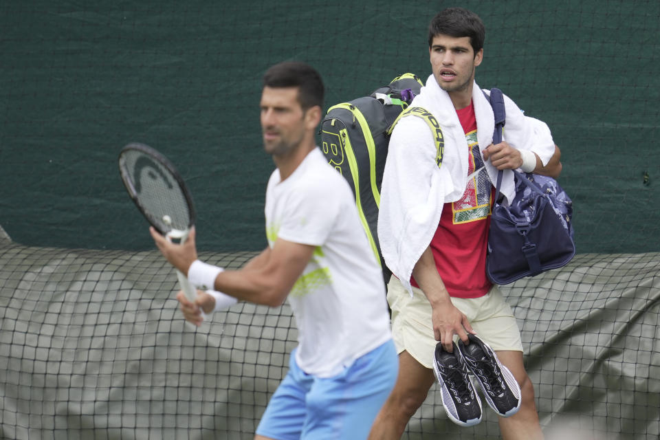 Novak Djokovic, left, and Carlos Alcaraz are both in the Wimbledon semifinals. (AP Photo/Kin Cheung)