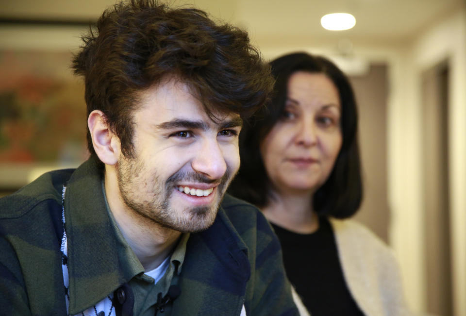 Tamara Tamimi and her son, Kinnan Abdalhamid, 20, speak about the Nov. 25, 2023, shooting that injured Kinnan and his two friends, an attack being investigated as a possible hate crime, during an interview Friday, Dec. 1, 2023, in Burlington Vt. The three friends, all college students of Palestinian descent, were shot at close range on a residential street in Burlington. (AP Photo/Hasan Jamali)