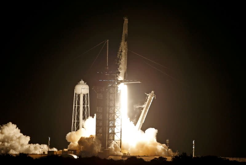 FILE PHOTO: A SpaceX Falcon 9 rocket, with the Crew Dragon capsule, is launched carrying four astronauts on a NASA commercial crew mission