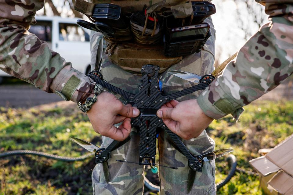 Serviceman of the 80th Airborne Assault Brigade prepares a FPV-drone for launching, in Donetsk region (REUTERS)