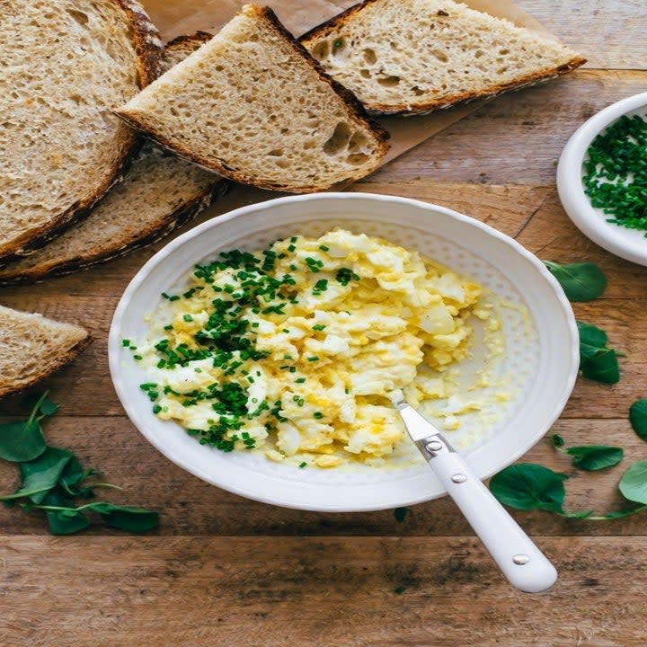 Egg salad in a bowl and bread on the side