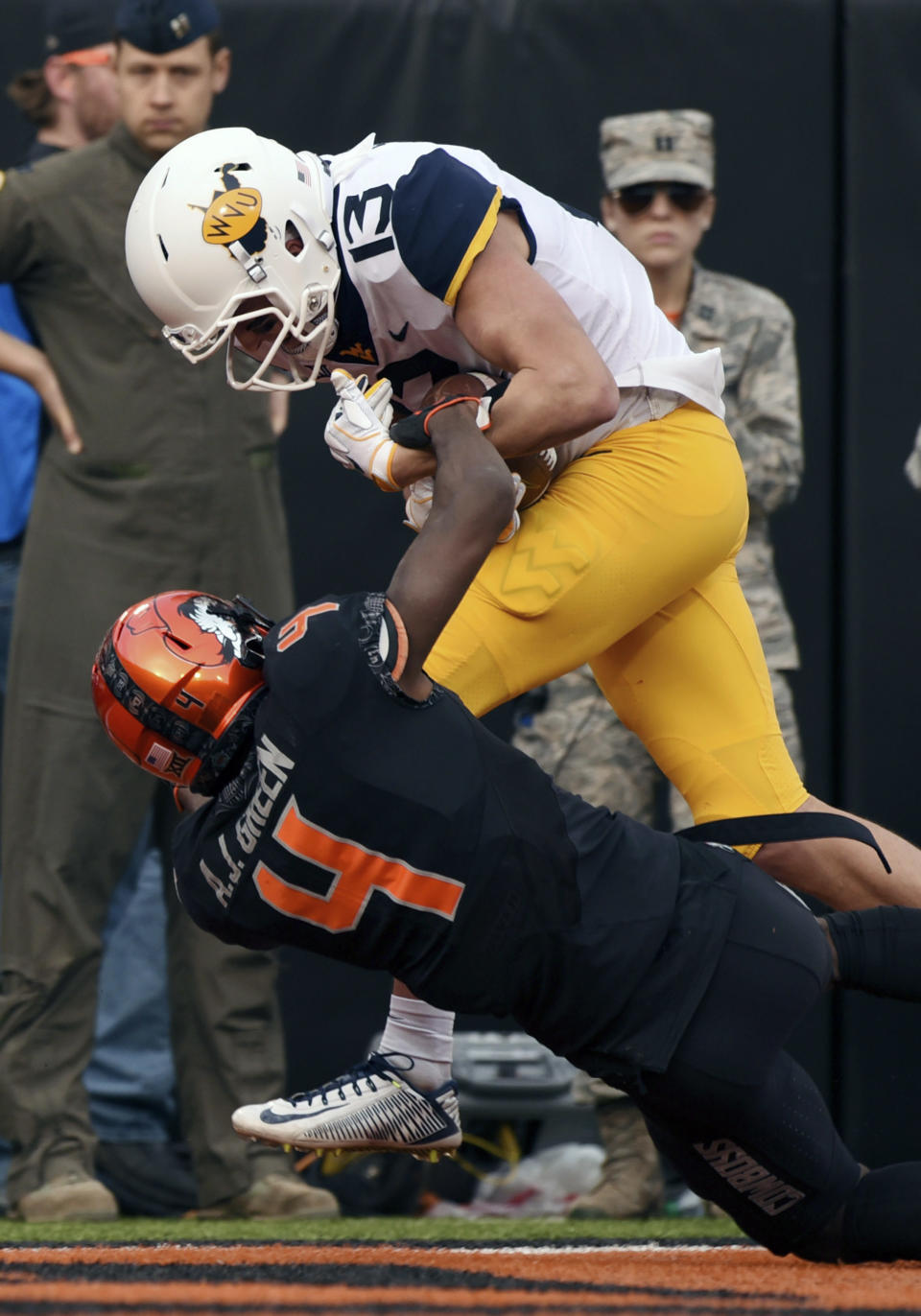 West Virginia wide receiver David Sills V struggles across the goal line while being tackled by Oklahoma State cornerback A.J. Green during the first half of an NCAA college football game in Stillwater, Okla., Saturday, Nov. 17, 2018. (AP Photo/Brody Schmidt)