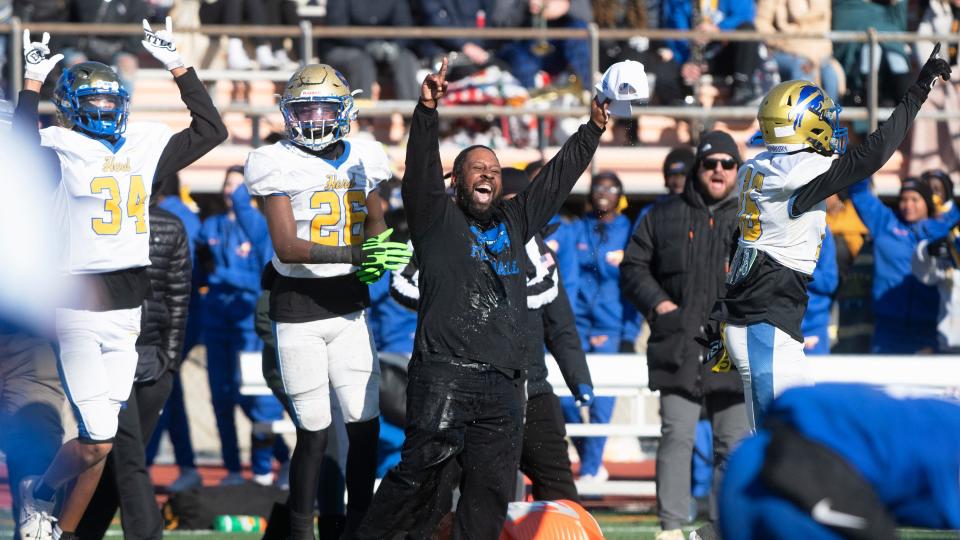 Woodbury High School's head football coach Anthony Reagan, center, celebrates with his players after Woodbury defeated Salem,   22-7, in the state Group 1 football semifinal game played at Cherokee High School in Marlton on Saturday, November 19, 2022.  