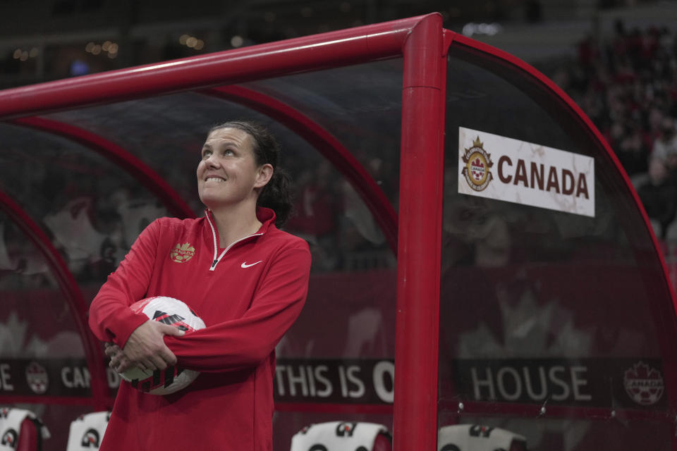 FILE - Canada's Christine Sinclair watches a video tribute as she is recognized for her international goal scoring record set in 2020, before the team's international friendly soccer match against Nigeria in Vancouver, British Columbia, Friday, April 8, 2022. Sinclair, the top goal scorer in international soccer, has announced she will retire from the Canadian national team at the end of this season. Sinclair, 40, announced her decision Thursday night, Oct. 19, 2023, on Instagram in a video that showed a pair of cleats swinging in the breeze on a goal.(Darryl Dyck/The Canadian Press via AP, File)