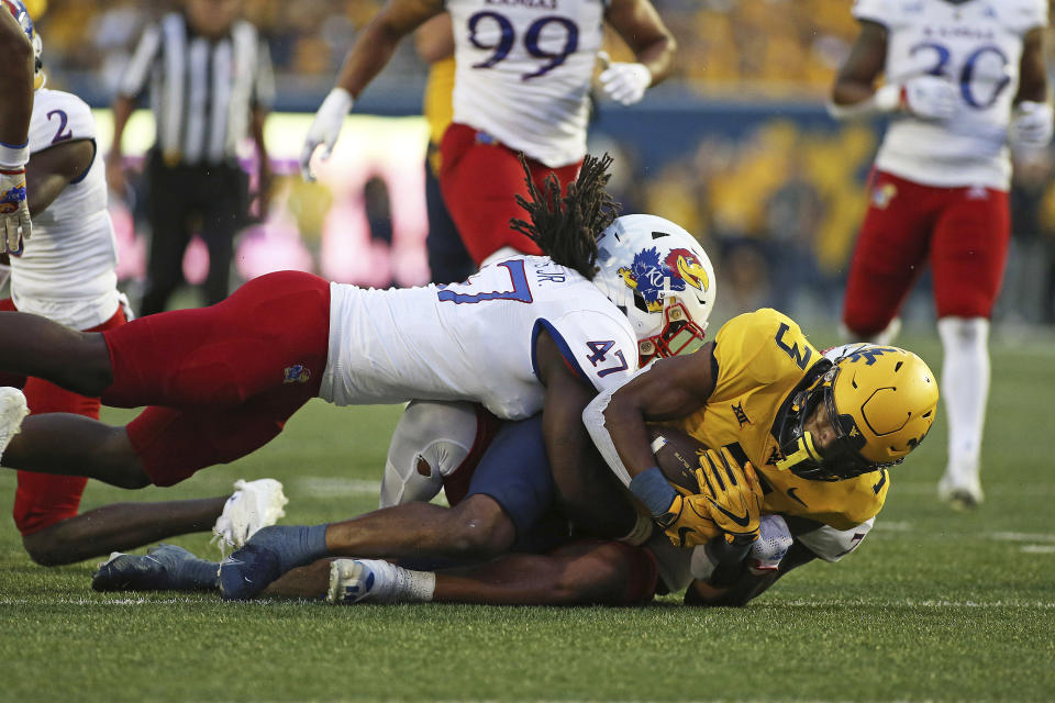 West Virginia wide receiver Kaden Prather (3) is defended by Kansas defensive end Lonnie Phelps (47) during the first half of an NCAA college football game in Morgantown, W.Va., Saturday, Sept. 10, 2022. (AP Photo/Kathleen Batten)