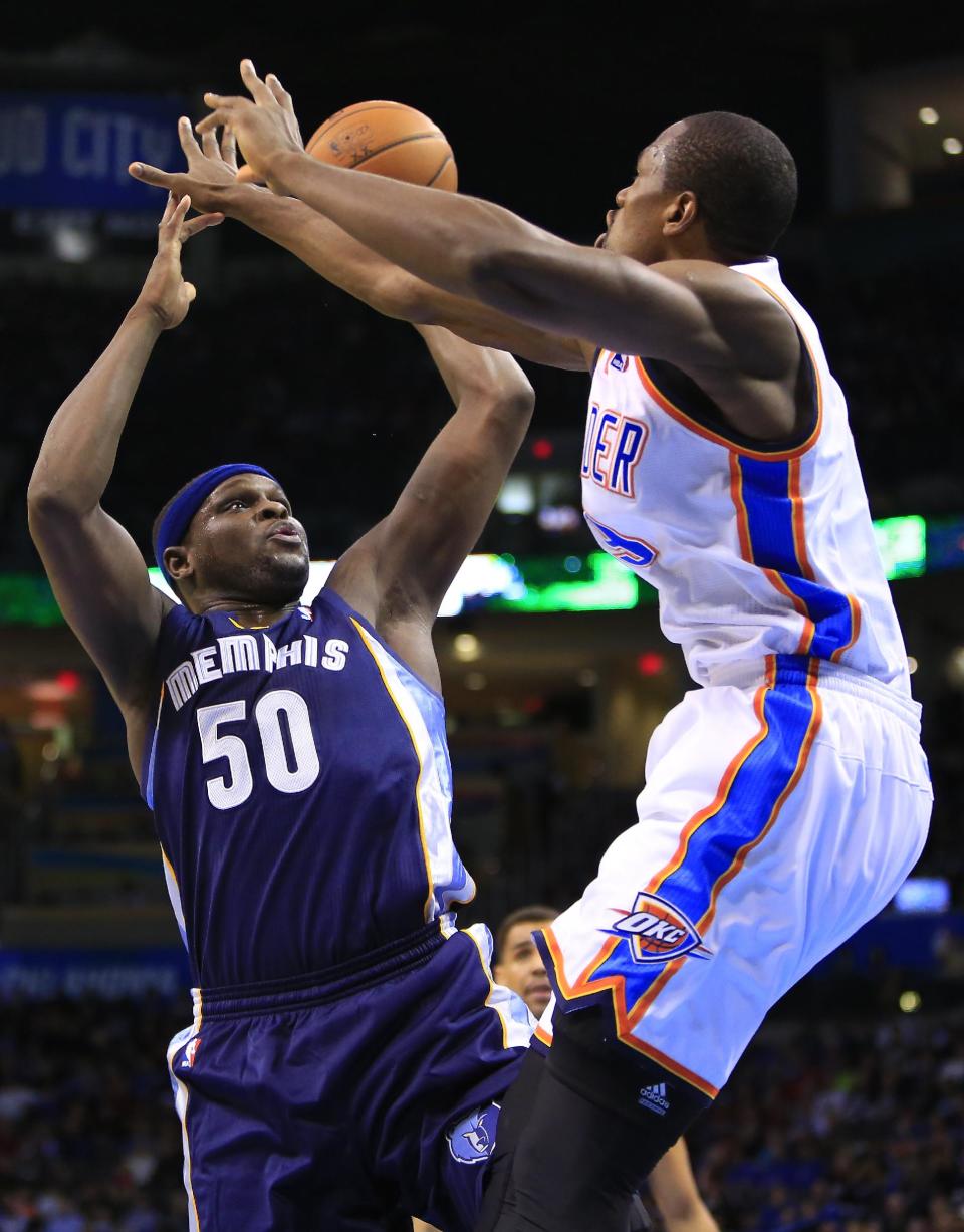 Memphis Grizzlies forward Zach Randolph (50) shoots as Oklahoma City Thunder forward Serge Ibaka (9) defends during the second quarter of an NBA basketball game on Monday, Feb. 3, 2014, in Oklahoma City. (AP Photo/Alonzo Adams)