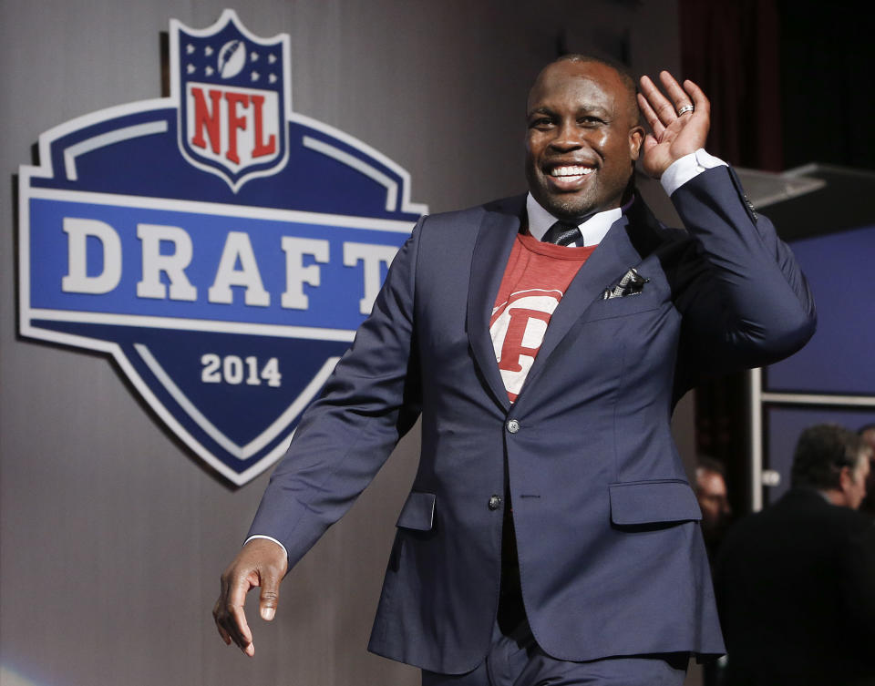 Former Washington Redskins linebacker London Fletcher reacts as he walks on stage for the second round of the 2014 NFL Draft, Friday, May 9, 2014, in New York. (AP Photo/Jason DeCrow)