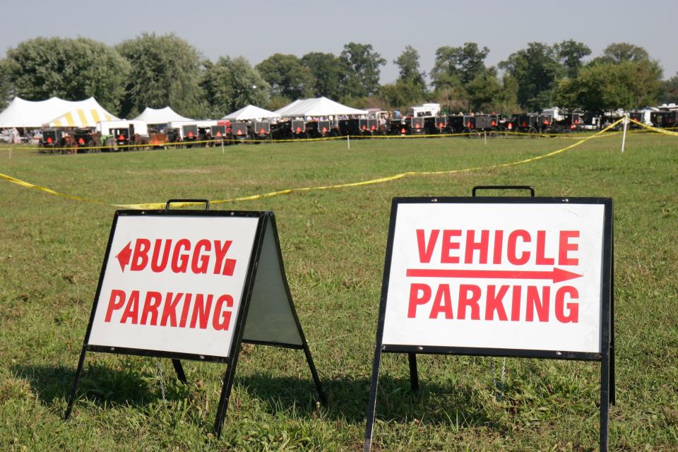 Amish buggy parking signs at a farm auction in Shipshewana.