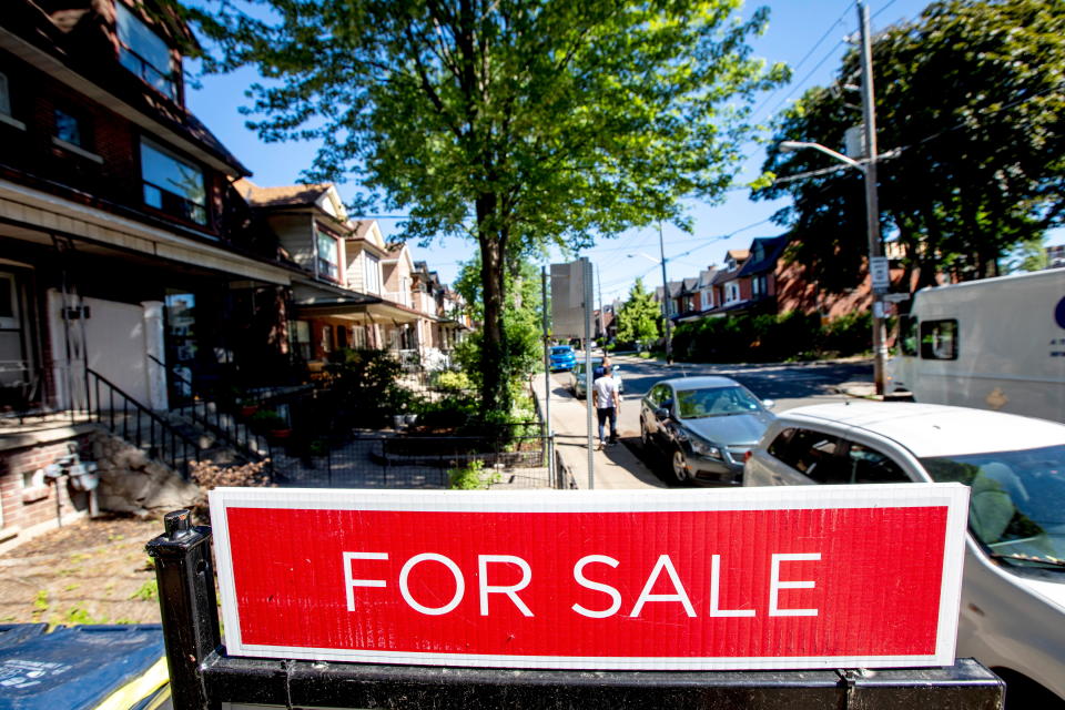 For sale sign is displayed outside a home in Toronto, Ontario, Canada June 15, 2021. REUTERS/Carlos Osorio