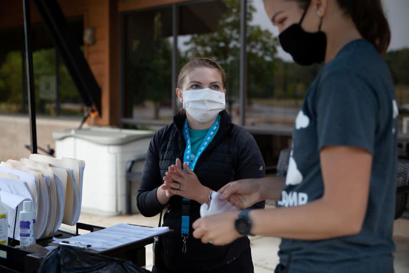 Children go through COVID-19 checks before summer camp