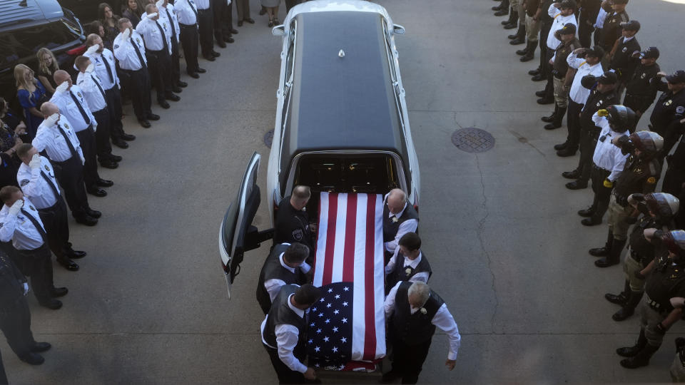 The casket of Santaquin Police Sgt. Bill Hooser arrives at Utah Valley University Monday, May 13, 2024, in Orem, Utah. Hooser was killed on May 5, 2024, while helping a Utah Highway Patrol trooper with a traffic stop when police say a man driving a semi-trailer intentionally hit Hooser. (AP Photo/Rick Bowmer)