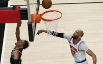 Atlanta Hawks' Trae Young (11) shoots and scores against New York Knicks' Taj Gibson (67) during the first half in Game 4 of an NBA basketball first-round playoff series Sunday, May 30, 2021, in Atlanta. (AP Photo/Brynn Anderson)