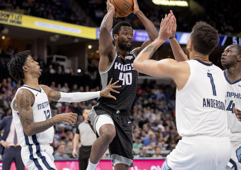 Sacramento Kings forward Harrison Barnes (40) looks to pass while defended by Memphis Grizzlies guard Ja Morant (12), forward Kyle Anderson (1) and center Gorge Dieng, right, during the first half of an NBA basketball game Friday, Feb. 28, 2020, in Memphis, Tenn. (AP Photo/Nikki Boertman)