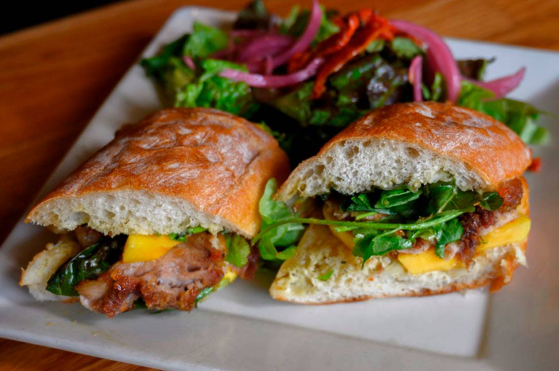 A Pork Belly (spicy) sandwich is ready to be served on Tuesday, April 23, 2019 in Sacramento. The “You Gotta Try This,” dish, is made of fatty pork belly along with pickled papaya and fennel, basil, cilantro, spicy honey and jalapeno aioli on a roll.