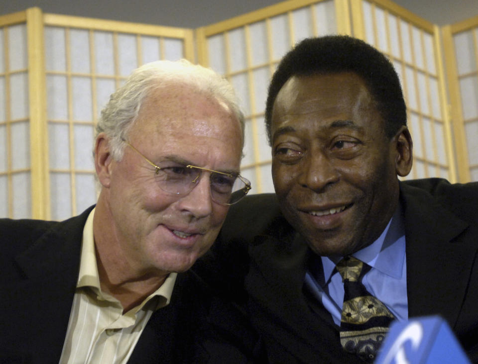 FILE - Soccer legends Franz Beckenbauer, left, and Edson Arantes Do Nascimento, known as Pele, embrace during a news conference Friday, April 7, 2006, in New York. Germany's World Cup-winning coach Franz Beckenbauer has died. He was 78. Beckenbauer was one of German soccer's central figures. He captained West Germany to the World Cup title in 1974. He also coached the national side for its 1990 World Cup win against Argentina. (AP Photo/Jason DeCrow, File)