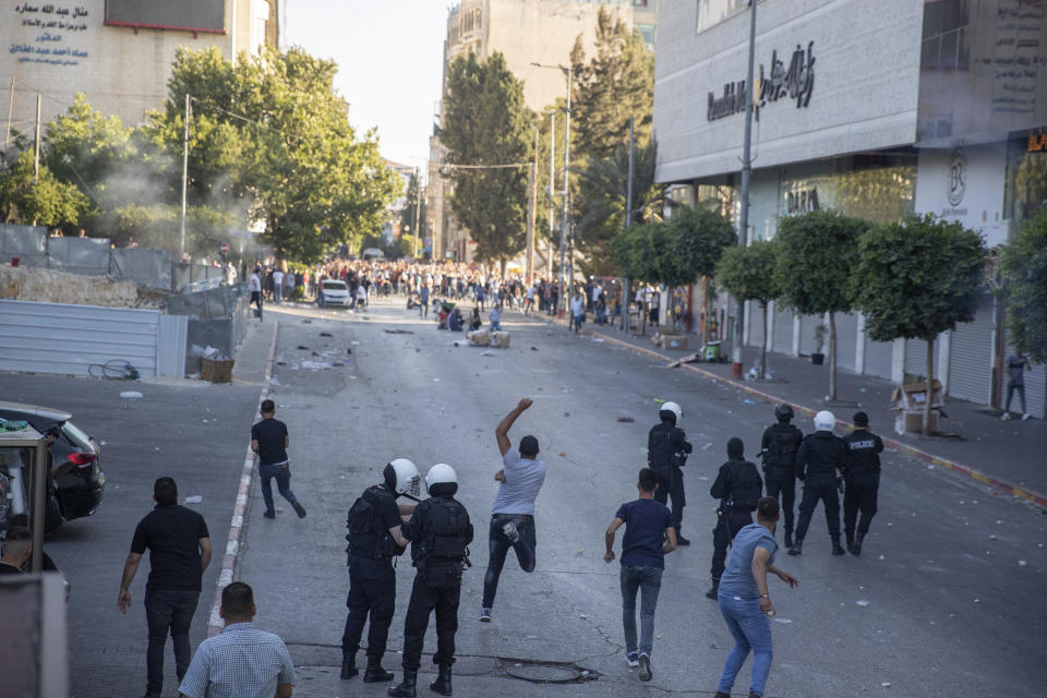 Palestinian riot police and plainclothes security officers clash with protesters following a demonstration against the death of Nizar Banat, a critic of the Palestinian Authority, in the West Bank city of Ramallah, Saturday, June 26, 2021. (AP Photo/Nasser Nasser)