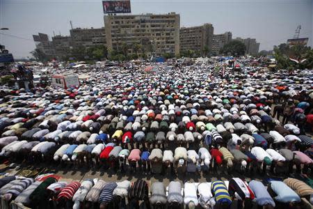 Supporters of then Egyptian President Mohamed Mursi perform prayers during a protest to show support to him at the Raba El-Adwyia mosque square in Cairo in this July 3, 2013 file photo. REUTERS/Khaled Abdullah/Files