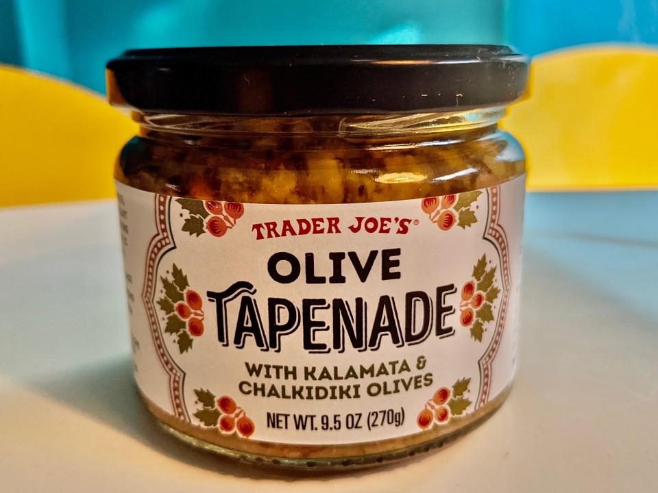 jar of trader joe's olive tapenade on a kitchen table