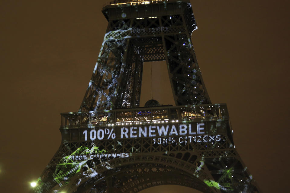 FILE- An artwork entitled 'One Heart One Tree' by artist Naziha Mestaoui is displayed on the Eiffel tower ahead of the 2015 Paris Climate Conference, in Paris, on Nov. 29, 2015. (AP Photo/Thibault Camus, File)